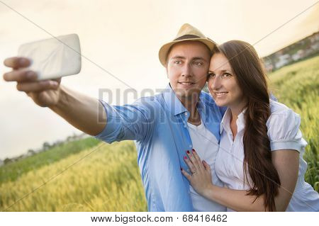 Pregnant couple taking selfie