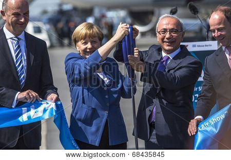 BERLIN, GERMANY - MAY 20, 2014: German Chancellor Angela Merkel, Turkish Minister of transport Lutfi Elvan and CEO Mr Christian (C.-R.) open up the International aviation and space exhibition ILA.