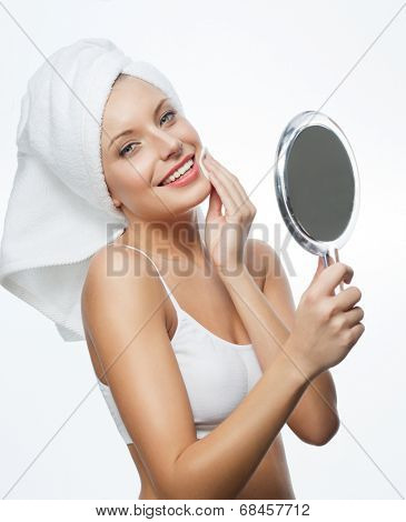 closeup portrait of attractive  caucasian smiling woman blond isolated on white studio shot lips toothy smile face hair head and shoulders looking at camera blue eyes towel mirrow cleaning cotton disc