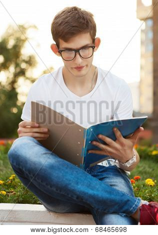 Student Reading His Notebook