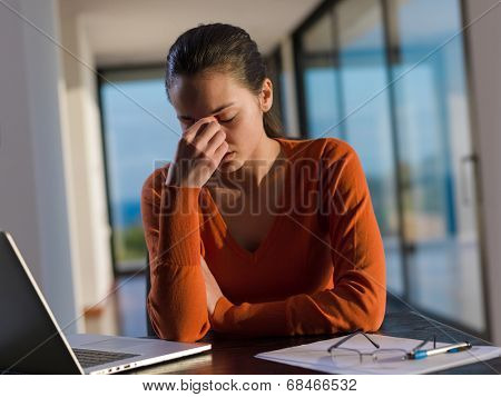 beautiful young woman relax and work on laptop computer while listening music on heaphones and read book at home