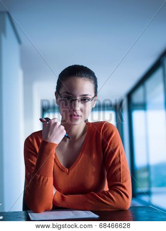 beautiful young woman relax and work on laptop computer while listening music on heaphones and read book at home