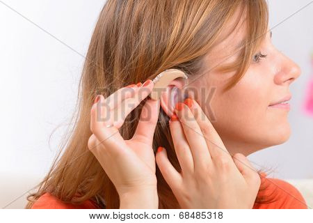Putting on a deaf aid