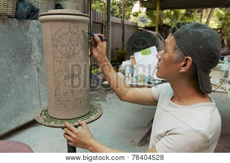 Man paints traditional tribal tattoo motives decoration, Kuching, Malaysia.