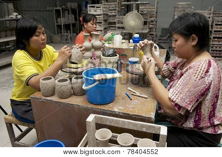 Women cut traditional tattoo motives decoration at kaolin, Kuching, Malaysia.