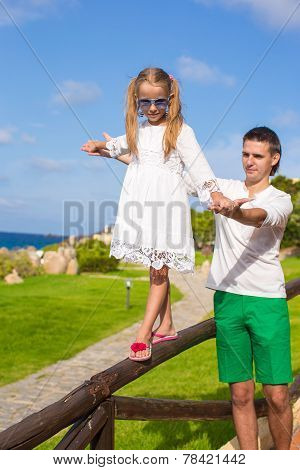 Happy father and his adorable little daughter outdoor