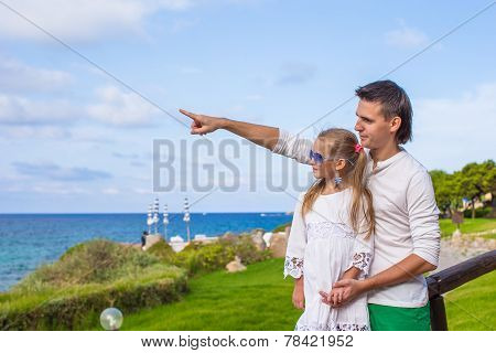 Happy young father and his adorable little daughter outdoors