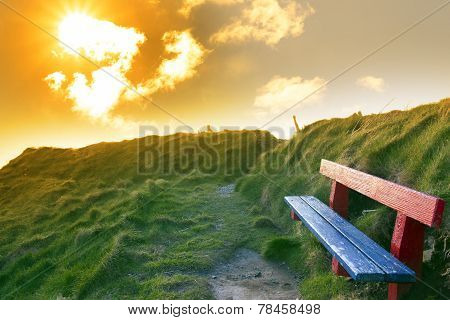Bench On A Cliff Edge With Sunset