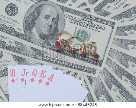 Gold Jewelry And Playing Cards On Us Dollars
