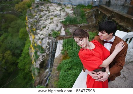 Young Beautiful Couple Kiss Near Waterfall