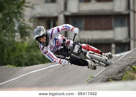 ST. PETERSBURG, RUSSIA - AUGUST 6, 2015: Unidentified biker on the berm in the BMX race Cruiser. The competitions is a stage of the BMX racing championship of Russia
