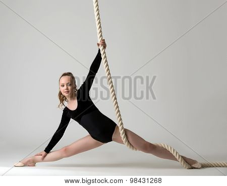 Photo of nice young gymnast training on rope
