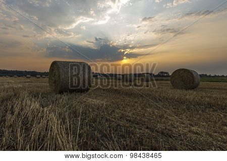 Sheaves of hay in the glow of the sunrise