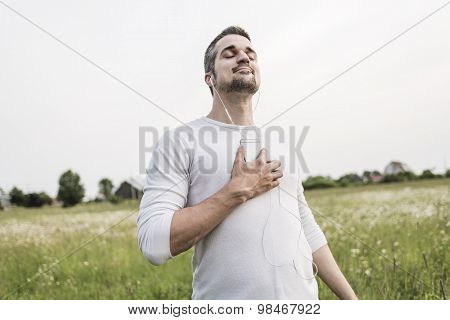 Happy young man in a field