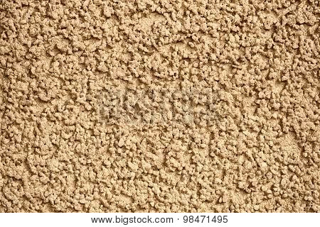 Yellow concrete wall with plaster.