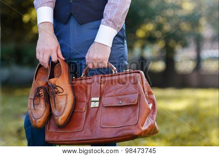 Men wear fashionable shoes standing on the green grass background.