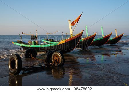 A row of boats on beach