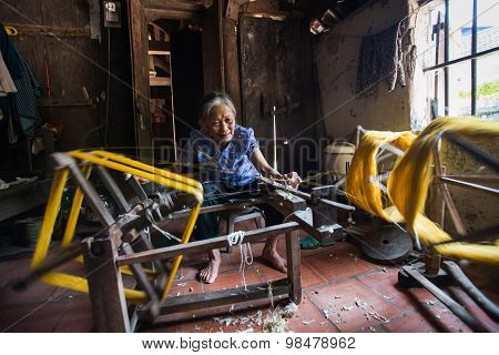 Old woman are weaving silk
