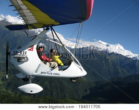 HIMALAYAS, POKHARA, NEPAL. 28 Sep 2008: a Foreign tourist flying on a hang glider (deltaplan).