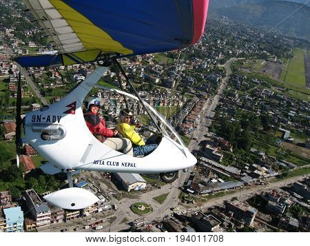 HIMALAYAS, POKHARA, NEPAL. 28 Sep 2008: a Foreign tourist flying on a hang glider (deltaplan).