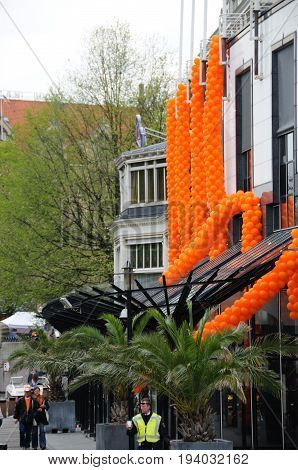 AMSTERDAM, NETHERLANDS - APRIL 30. Decorations for Queensday in Amsterdam. Queensday is a popular annual festival celebrating the Queens Birthday.