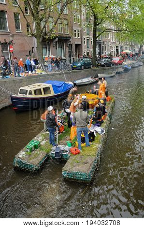 AMSTERDAM, NETHERLANDS - APRIL 30. Young People Celebrating Queensday in Amsterdam. Queensday is a popular annual festival celebrating the Queens Birthday.