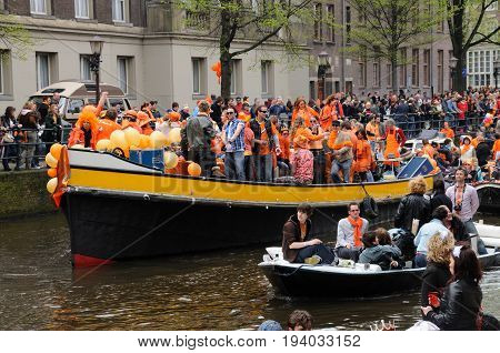 AMSTERDAM, NETHERLANDS - APRIL 30. Young People Celebrating Queensday in Amsterdam. Queensday is a popular annual festival celebrating the Queens Birthday.