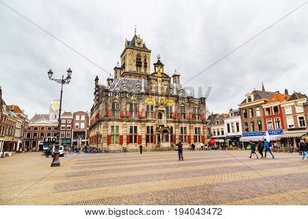 Delft, Netherlands - April 6, 2016: Stadhuis or City Hall, Markt square, houses, people in Delft, Holland