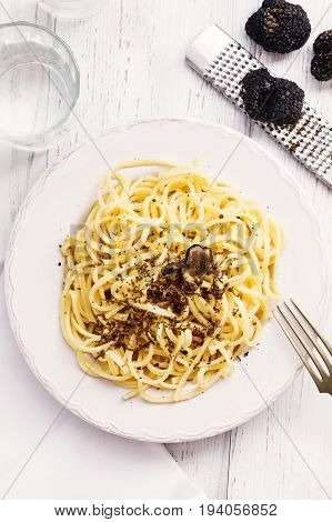 Strangozzi italian wheat pasta with truffle on a light background.