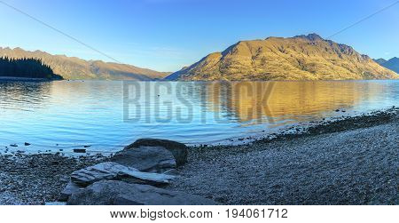 Panoramic serenity of beautiful Lake Wakatipu in the morning in Autumn Queenstown South Island of New Zealand