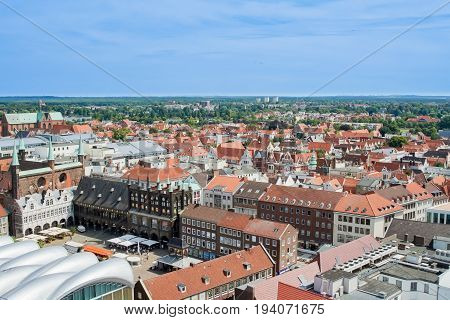 Top view of the beautiful old city with red-tiled roofs and spires
