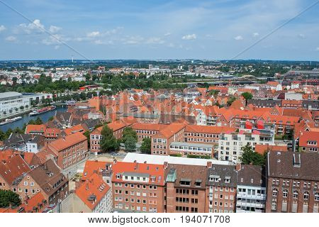 Top view of the beautiful old city with red-tiled roofs and spires