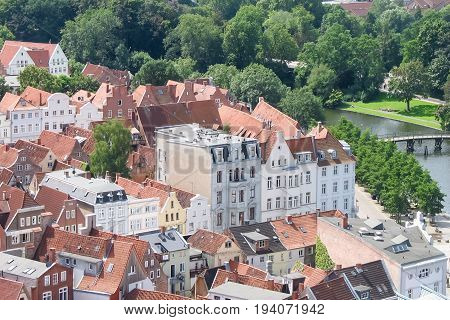 Top view of the beautiful old city with red-tiled roofs and spires