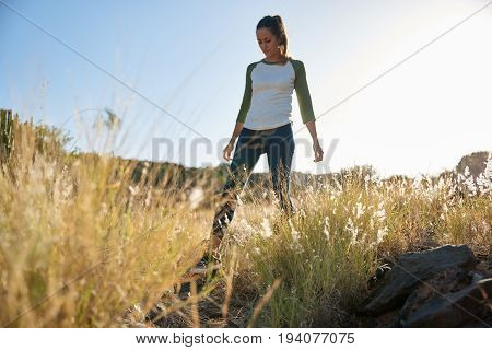 Young Girl Walking Through Long Grass