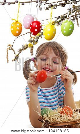 a little girl coloring easter eggs close up