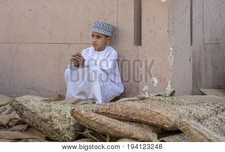 Nizwa Oman June 23rd 2017: omani boy in traditional clothing at a market