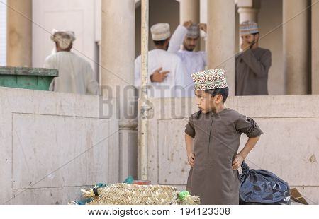 Nizwa Oman June 23rd 2017: omani boy in traditional clothing at a market