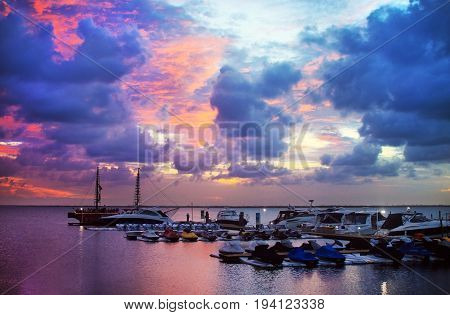 Yachts and water bikes parking in the harbor in sunset. Laguna Nichupte in Cancun Mexico.