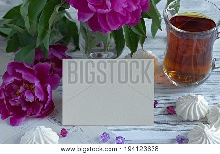 Peonies Flowers Pink Glass Of Tea With Greeting Card Marshmallow On A White Wooden Background - Stoc