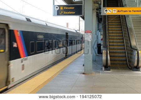NEWARK, NEW JERSEY, USA - APRIL 25, 2016 - A train in motion arriving at a Newark International Airport train station, New Jersey, USA