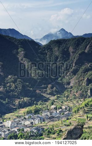 The village of Shanglingyancun and a terraced tea garden surrounded by the mountains in the Fangdong scenic area of Yandangshan located in Zhejiang province China.