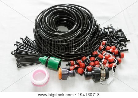 A set of tools for drip irrigation of plants and garden: hose sprinklers joints hose holders.