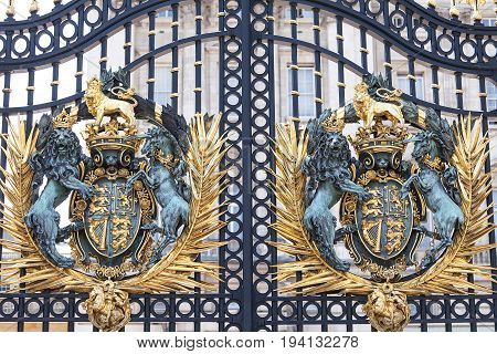 Buckingham Palace decorative entrance gate with Royal coat of arms London United Kingdom. Palace is the London residence and administrative headquarters of the reigning monarch of the United Kingdom