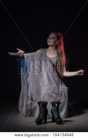 Actress In A Grey Dress On A Dark Stage