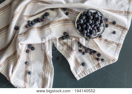 Blueberries in a bowl on a stripped cloth