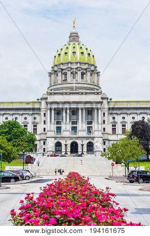 Harrisburg USA - May 24 2017: Pennsylvania capitol exterior in city with many red pink rose bushes and street