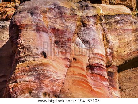 Red Yellow Rocks Near Royal Tombs Petra Jordan Built by the Nabataens in 200 BC to 400 AD. Rose Red canyon walls create many abstracts close up. Reds are created by magnesium in sandstone.