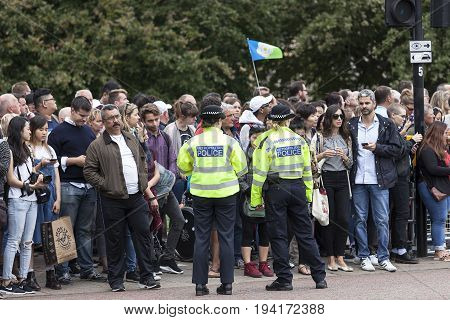 LONDON UNITED KINGDOM - JUNE 25 2017 : Metropolitan police and tourist waiting for ceremonial changing of the London guards in front of the Buckingham Palace. This is one of the major attractions in London.