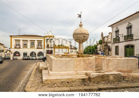 EVORA,PORTUGAL - MAY 16,2017 - Fountain Porta de Moura in the streets of Evora in Portugal. Evora is a pleasant medium-sized city and has numerous monuments.