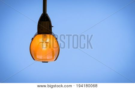 Light pole on blue sky background in twilaght period